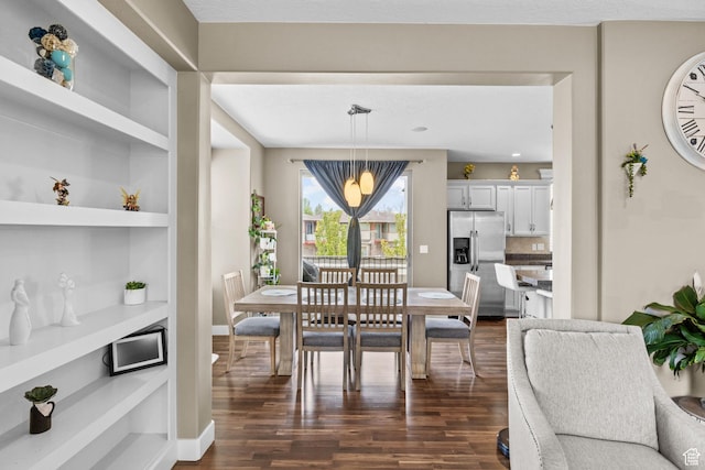 dining area featuring baseboards, dark wood-style floors, and built in features