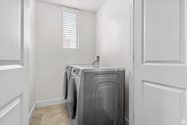 laundry area featuring baseboards, washer and dryer, and laundry area