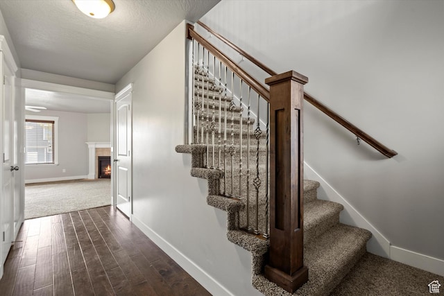 286 S Bing Cherry Way, Layton, UT 84040 - stairs with wood finished floors, baseboards, and a lit fireplace