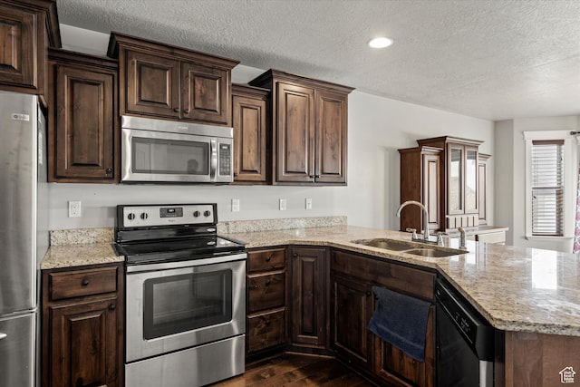 286 S Bing Cherry Way, Layton, UT 84040 - kitchen featuring a sink, a peninsula, a textured ceiling, appliances with stainless steel finishes, and dark wood-style flooring