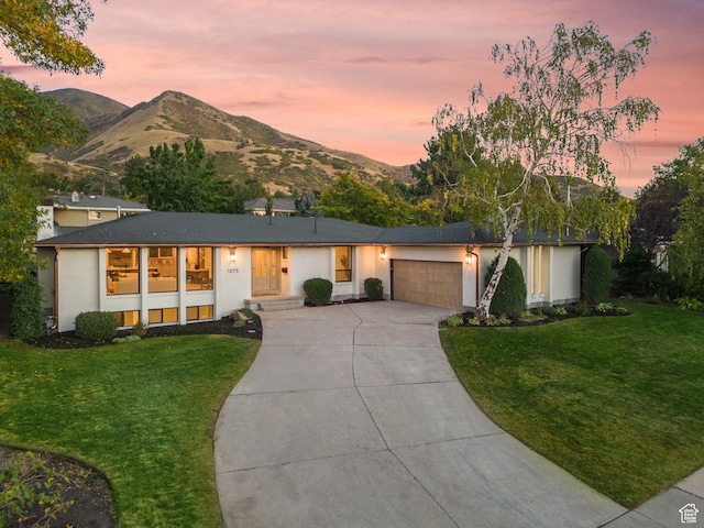 1075 S Alton Way E, Salt Lake City, UT 84108 - single story home with an attached garage, a lawn, driveway, and a mountain view