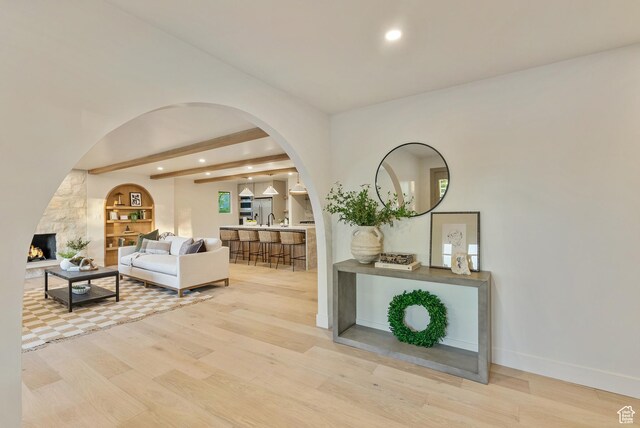 1075 S Alton Way E, Salt Lake City, UT 84108 - living area featuring arched walkways, beamed ceiling, light wood finished floors, baseboards, and recessed lighting