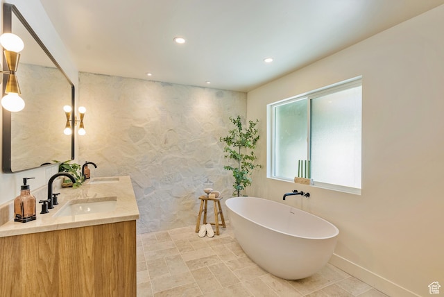 1075 S Alton Way E, Salt Lake City, UT 84108 - full bathroom featuring recessed lighting, double vanity, a sink, baseboards, and a freestanding tub