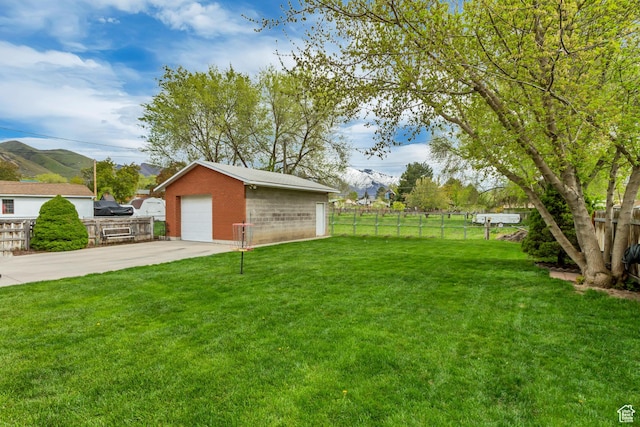 1240 E Center St, Springville, UT 84663 - view of yard featuring concrete driveway, fence, an outbuilding, a mountain view, and a garage