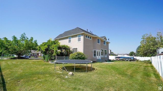 1229 E 1710 S, Spanish Fork, UT 84660 - back of house featuring fence, a lawn, stucco siding, and a trampoline