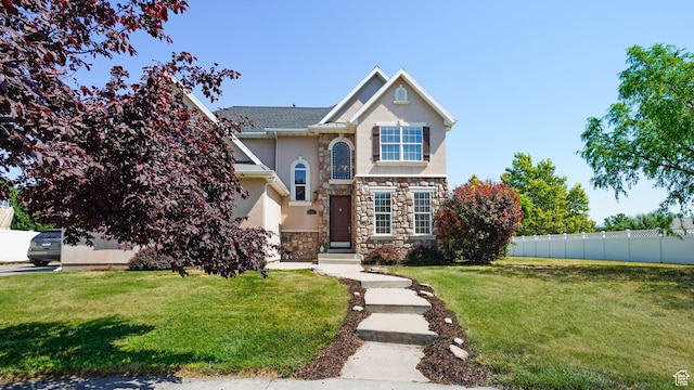1229 E 1710 S, Spanish Fork, UT 84660 - traditional-style house featuring stucco siding, a front lawn, fence, and stone siding