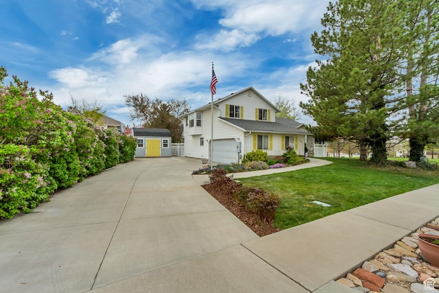217 W 990 N, American Fork, UT 84003 - traditional home featuring a storage shed, concrete driveway, an attached garage, an outdoor structure, and a front yard
