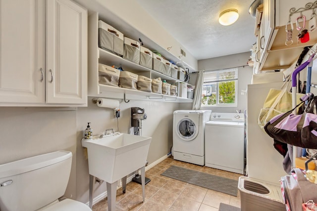 217 W 990 N, American Fork, UT 84003 - washroom with washing machine and clothes dryer, light tile patterned flooring, a textured ceiling, and baseboards