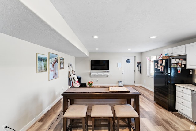 2671 E White Birch Dr, Eagle Mountain, UT 84005 - dining space with recessed lighting, baseboards, a textured ceiling, and light wood-style floors