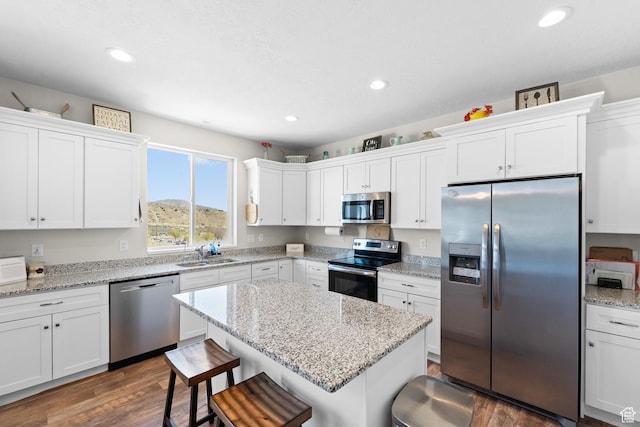 2671 E White Birch Dr, Eagle Mountain, UT 84005 - kitchen featuring white cabinetry, appliances with stainless steel finishes, a breakfast bar area, and a sink