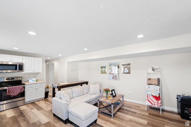2671 E White Birch Dr, Eagle Mountain, UT 84005 - living area featuring recessed lighting, light wood-type flooring, and baseboards