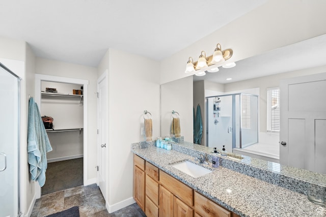 2671 E White Birch Dr, Eagle Mountain, UT 84005 - bathroom with a shower stall, vanity, a walk in closet, stone finish flooring, and baseboards