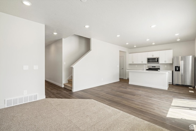 3509 N Gina St Unit 1230, Eagle Mountain, UT 84005 - unfurnished living room with dark wood-style floors, recessed lighting, and stairway
