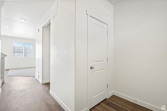 3509 N Gina St Unit 1230, Eagle Mountain, UT 84005 - corridor featuring dark wood-style floors and a textured ceiling