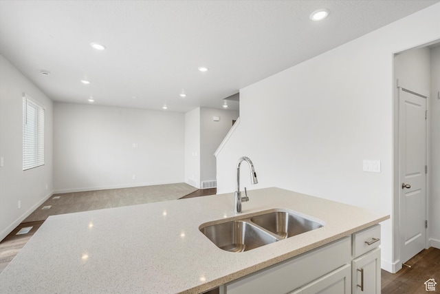 3509 N Gina St Unit 1230, Eagle Mountain, UT 84005 - kitchen with white cabinetry, light stone counters, recessed lighting, wood finished floors, and open floor plan