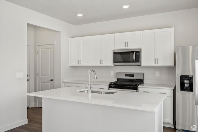 3509 N Gina St Unit 1230, Eagle Mountain, UT 84005 - kitchen with appliances with stainless steel finishes, dark wood finished floors, white cabinets, a kitchen island with sink, and light stone counters