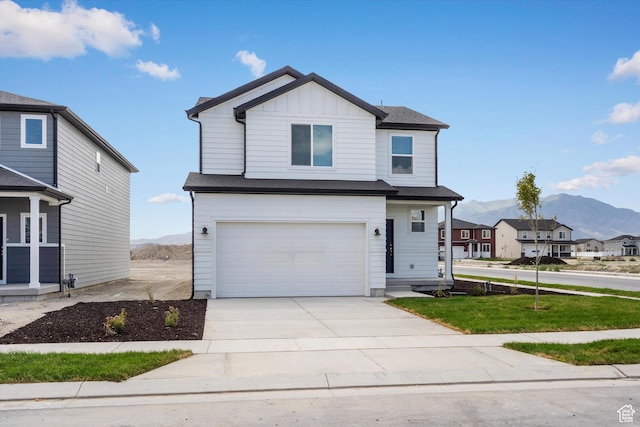 3509 N Gina St Unit 1230, Eagle Mountain, UT 84005 - view of front of home featuring a mountain view, an attached garage, concrete driveway, and board and batten siding