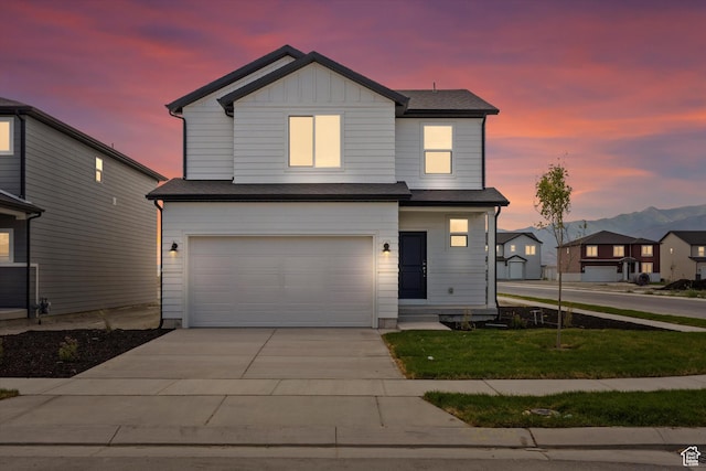 3509 N Gina St Unit 1230, Eagle Mountain, UT 84005 - view of front facade featuring an attached garage, driveway, and board and batten siding
