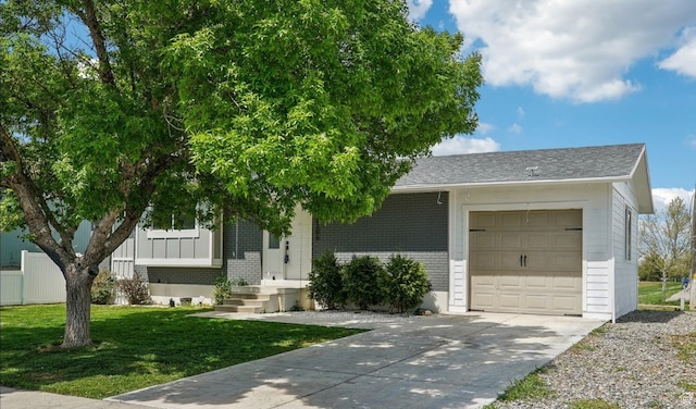 view of front of home featuring an attached garage, brick siding, concrete driveway, a front yard, and a shingled roof