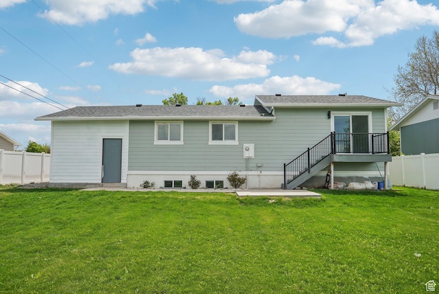 back of house featuring a yard, fence, a patio area, and stairs