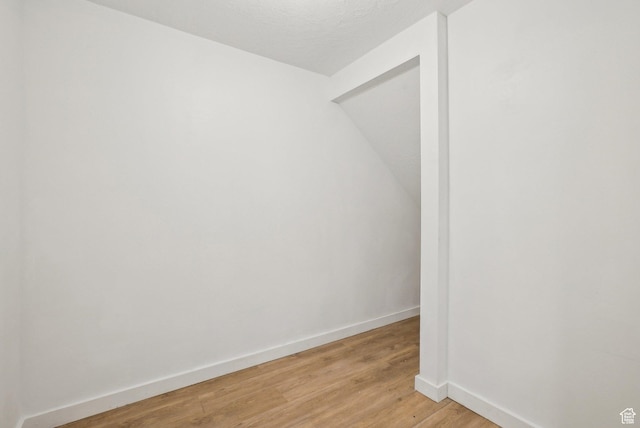empty room with baseboards and light wood-style floors