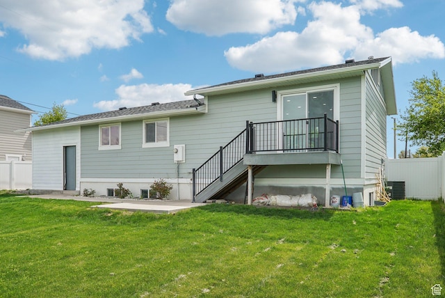 rear view of house featuring a yard, fence, a patio, central air condition unit, and stairway