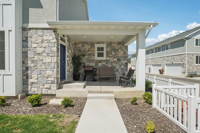 view of patio with a porch and fence