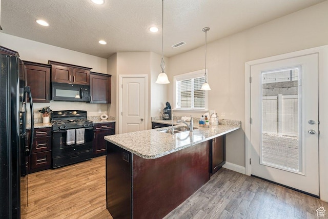 3030 N 125 E, Cedar City, UT 84721 - kitchen featuring a peninsula, a sink, visible vents, light wood-style floors, and black appliances