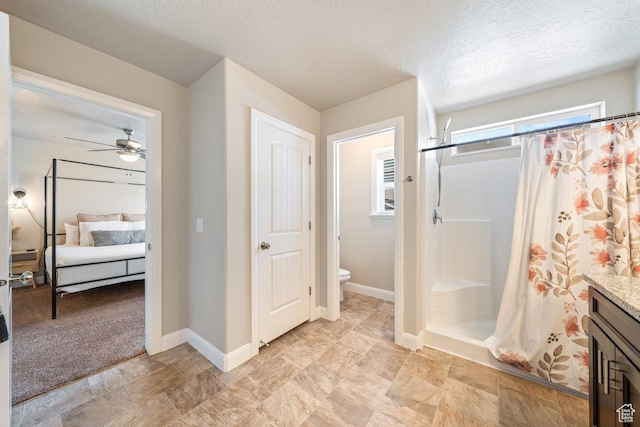 3030 N 125 E, Cedar City, UT 84721 - bathroom featuring a shower stall, a ceiling fan, connected bathroom, baseboards, and toilet