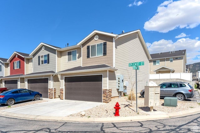 3030 N 125 E, Cedar City, UT 84721 - view of property featuring an attached garage, driveway, and stone siding
