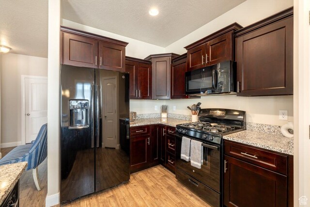 3030 N 125 E, Cedar City, UT 84721 - kitchen featuring light wood-type flooring, light stone counters, a textured ceiling, and black appliances