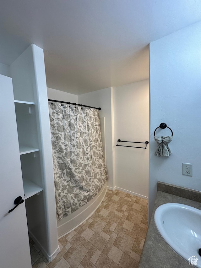1688 N 80 E, Tooele, UT 84074 - full bathroom featuring a shower with curtain, baseboards, and a sink