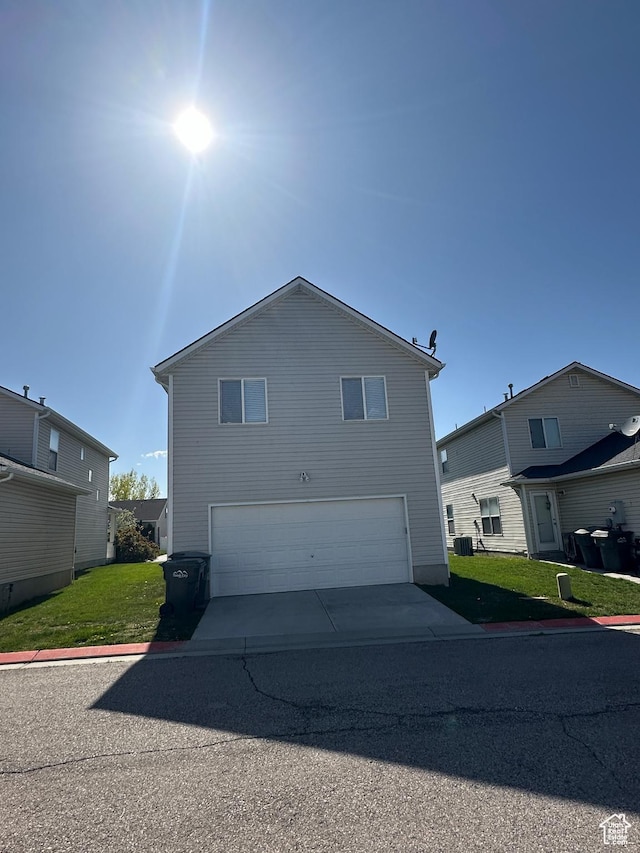 1688 N 80 E, Tooele, UT 84074 - view of front of house with a garage, central AC, a front yard, and concrete driveway