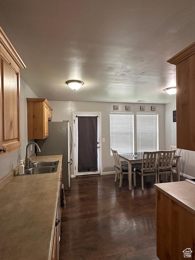 1688 N 80 E, Tooele, UT 84074 - kitchen featuring light brown cabinets, a sink, light countertops, baseboards, and dark wood-style floors
