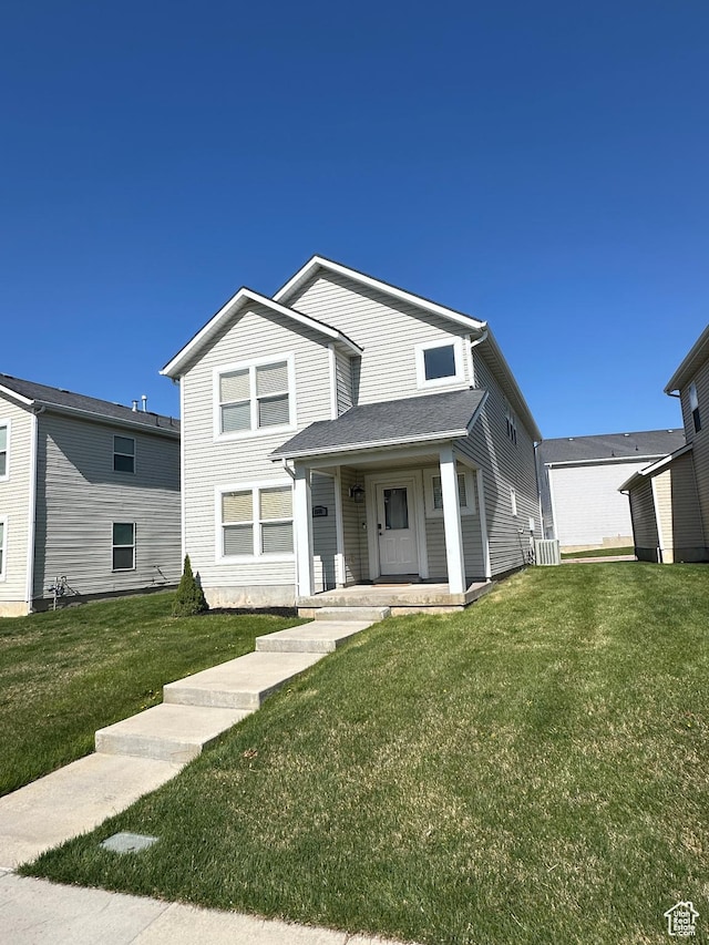 traditional home with a porch and a front lawn