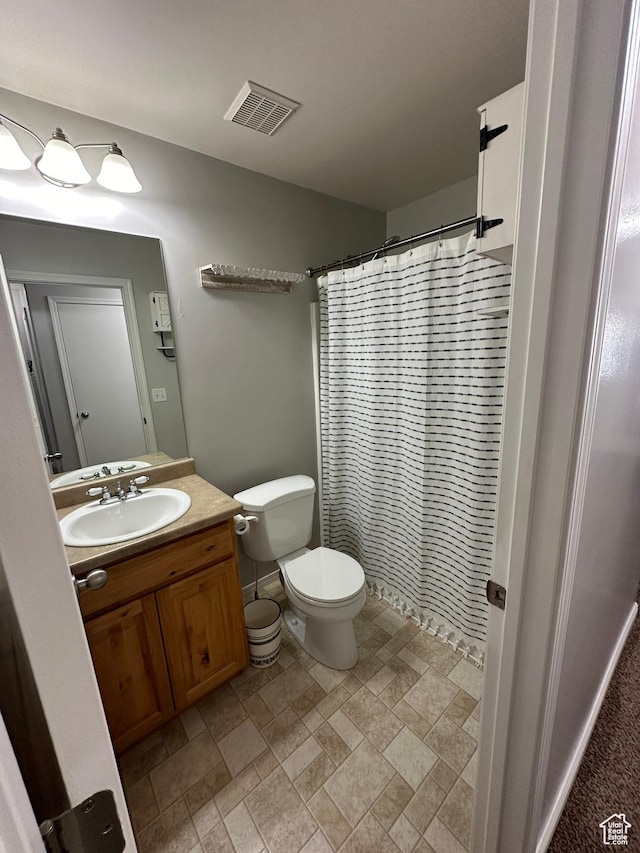 1688 N 80 E, Tooele, UT 84074 - bathroom with toilet, visible vents, stone finish floor, curtained shower, and vanity