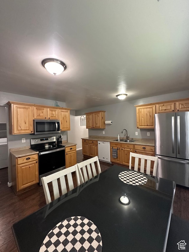 1688 N 80 E, Tooele, UT 84074 - kitchen featuring dark wood-type flooring, stainless steel appliances, light countertops, and a sink
