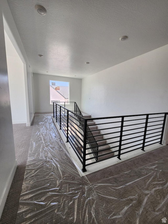4197 N Maple Hollow Dr Unit 120, Lehi, UT 84043 - stairway featuring a textured ceiling and baseboards