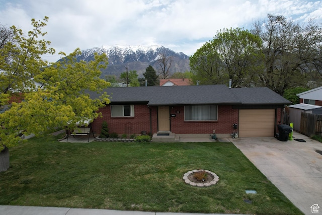ranch-style house with a front lawn, concrete driveway, fence, brick siding, and a garage