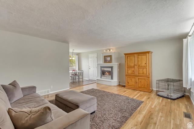 831 S 50 W, Orem, UT 84058 - living room featuring light wood-style floors, a textured ceiling, and visible vents