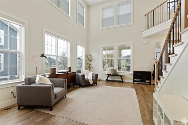 314 W Founders Blvd S, Saratoga Springs, UT 84045 - living area with a high ceiling, visible vents, stairs, baseboards, and hardwood / wood-style flooring