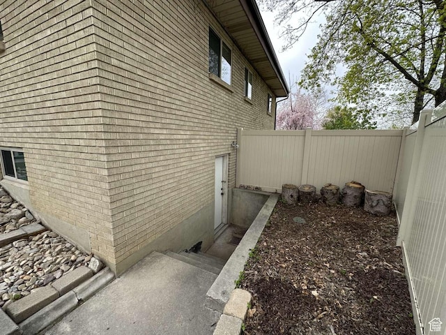 5843 S Fontaine Bleu Cir, Salt Lake City, UT 84121 - view of side of property with brick siding and fence