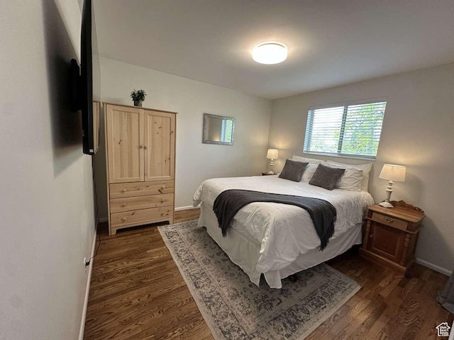 5843 S Fontaine Bleu Cir, Salt Lake City, UT 84121 - bedroom featuring baseboards and dark wood-style floors