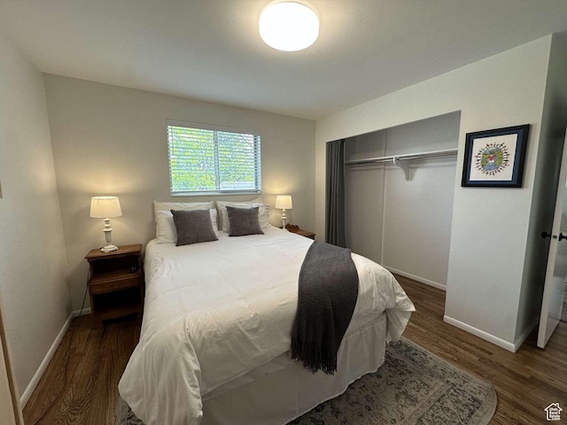 5843 S Fontaine Bleu Cir, Salt Lake City, UT 84121 - bedroom with wood finished floors, a closet, and baseboards