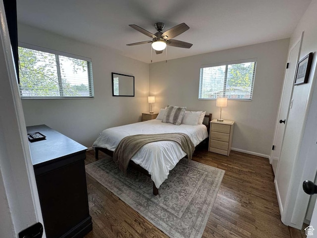 5843 S Fontaine Bleu Cir, Salt Lake City, UT 84121 - bedroom with dark wood finished floors, baseboards, and ceiling fan