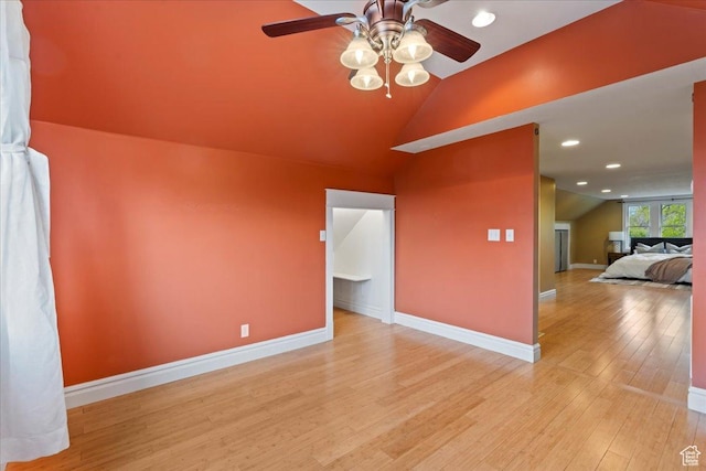 unfurnished room featuring recessed lighting, light wood-style flooring, baseboards, a ceiling fan, and lofted ceiling