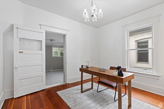 office area featuring an inviting chandelier, wood finished floors, and baseboards