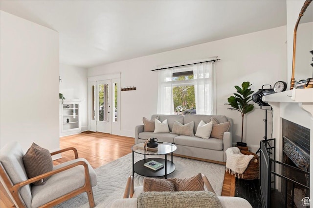 living area featuring wood finished floors and a healthy amount of sunlight