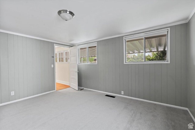 carpeted empty room featuring baseboards and visible vents