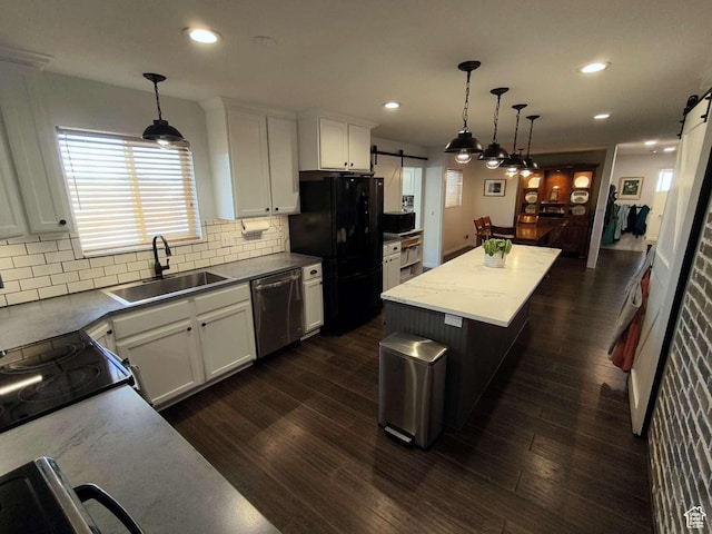 410 E 500 N, Ephraim, UT 84627 - kitchen with a barn door, dishwasher, a sink, freestanding refrigerator, and decorative backsplash